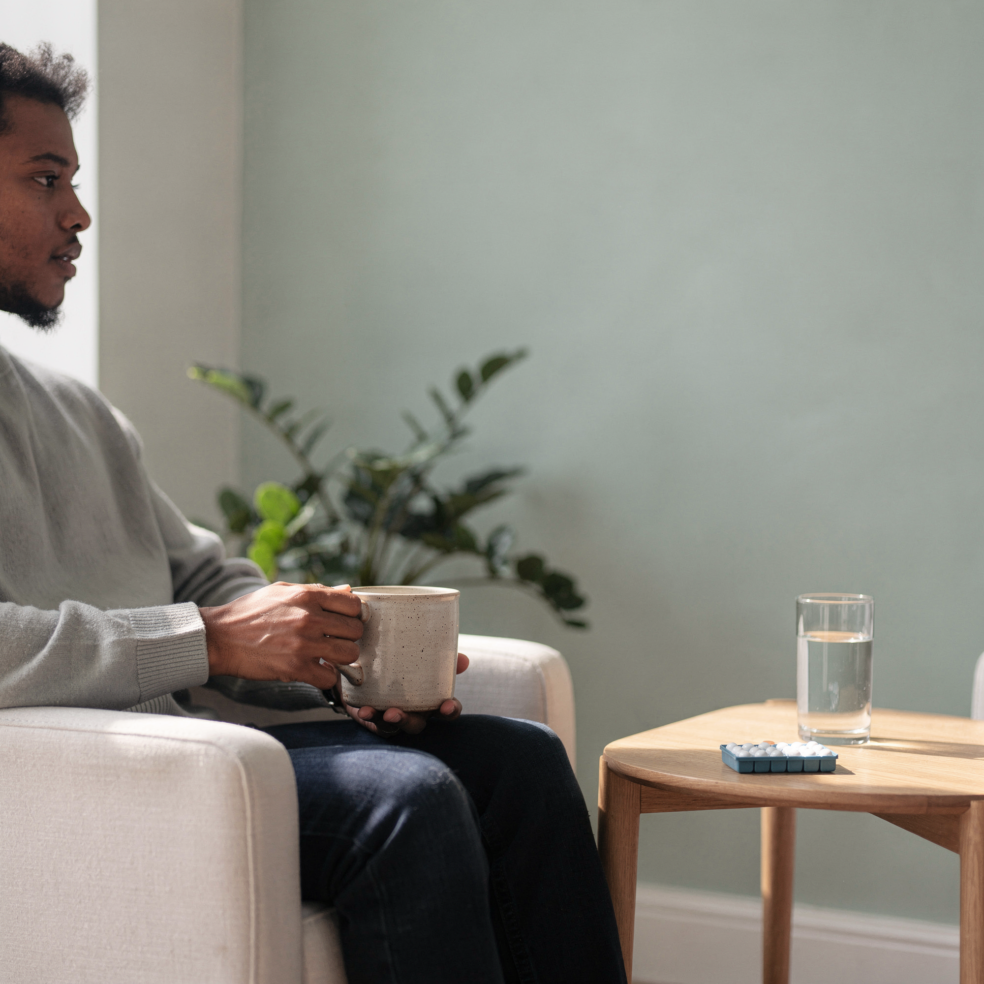 Man holding a mug in a consultation room – psychiatrist in Abington, PA